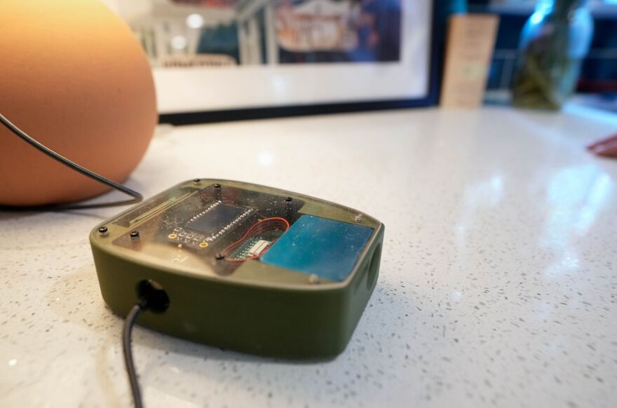 A PM2.5 fine particulate matter monitor is pictured in Tegan Spangrude’s kitchen, a west side resident who allowed the air monitoring device to be installed in her home for an extended study on Monday, August. 12, 2024.