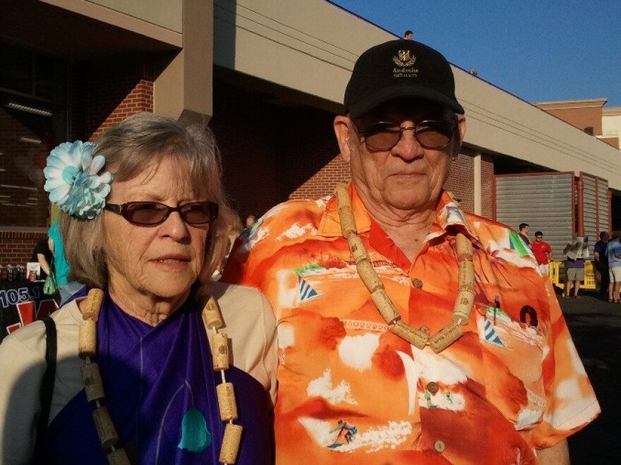 Two Trader Joe's fans at the store opening on Ward Parkway early Friday morning sport Hawaiian shirts and corks from the store's wine bottles. Photo by Sylvia Maria Gross/KCUR.