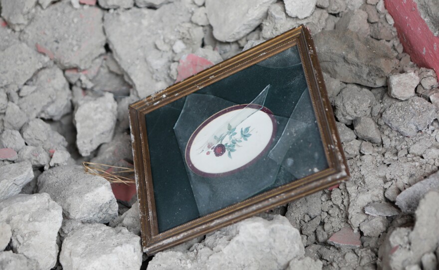 A picture frame is seen in rubble from a home that was destroyed by the earthquake that struck the city of Les Cayes, Haiti, on Saturday.
