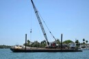 The barge from the vessel collision near Hibiscus Island, July 28, 2025. Coast Guard crews are investigating the potential causes of the fatal incident.