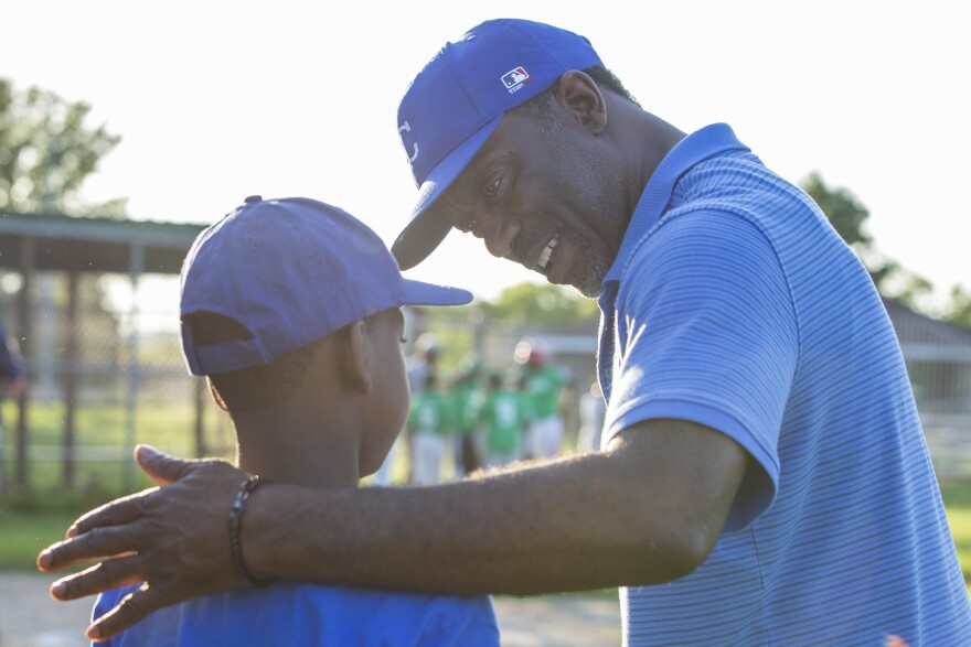 Charleston motivates Zion Singletary, 9, between innings.