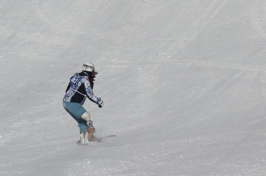 Amanda Seward snowboards with a prosthetic leg at Snowmass Ski Area on Thursday, April 4, 2024. Seward’s right leg was amputated after she was injured in a car accident on her way to drill with the Army Guard Reserve, and found a sense of community and freedom in winter sports.