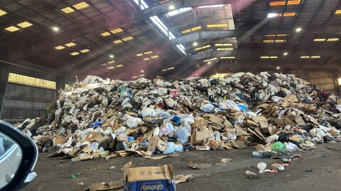The “tipping floor,” where compactors shovel piles of trash before transport to the landfill. Hazardous waste is housed in a separate facility. (Natalie Kaufman/WUFT News)
