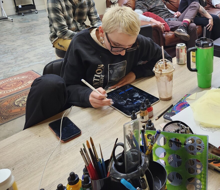 Woman works on an electronic tablet.