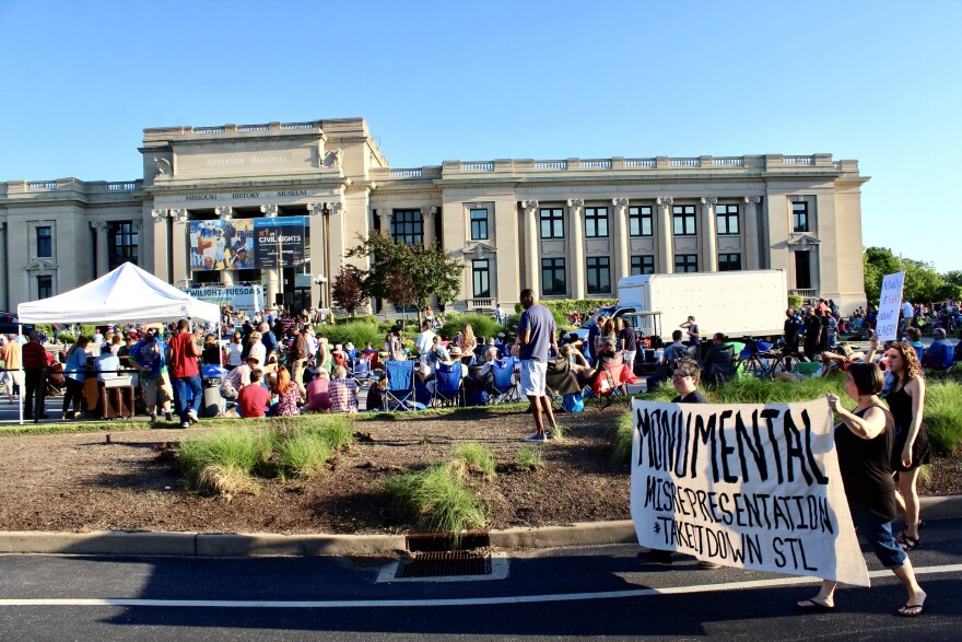 #TakeItDownSTL marchers walk through the crowd of concertgoers out for Twilight Tuesday, passing out pamphlets after being stopped by police on Tues., May 30, 2017.