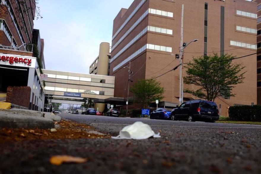 In a file photo, a face mask lies on the ground outside Ochsner Baptist during New Orleans' first wave of the pandemic.