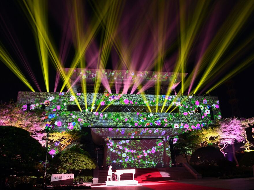 An image of flowers is beamed onto the Peace House where the historic summit between the North and South Korean leaders took place, during the closing ceremony.