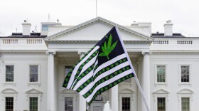FILE - A demonstrator waves a flag with marijuana leaves depicted on it during a protest calling for the legalization of marijuana, outside of the White House on April 2, 2016, in Washington. President Joe Biden is pardoning thousands of Americans convicted of “simple possession” of marijuana under federal law, as his administration takes a dramatic step toward decriminalizing the drug and addressing charging practices that disproportionately impact people of color.