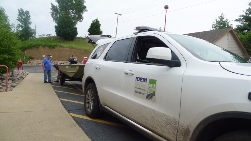Workers with the Indiana Department of Natural Resources continue to test for cyanide and ammonia-nitrogen in the Little Calumet River in Portage, Indiana. Here, the workers are setting up at the Portage Public Marina.