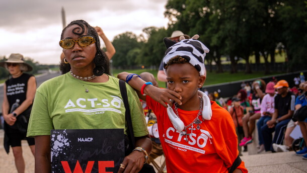Demonstrators listen to speakers during the March on Washington, Friday, Aug. 28, 2026, near the Lincoln Memorial in Washington. (AP Photo/Julia Demaree Nikhinson)