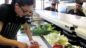 Australian celebrity chef and author Kylie Kwong (left) teaches a cooking workshop at Yaama Dhiyaan, a cooking and hospitality school for at-risk aborginal youth.