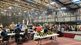 Groups of students work together on projects at an event.