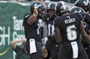 South Florida quarterback Byrum Brown (17) celebrates his touchdown against Boise State with wide receiver Keshaun Singleton (11) and wide receiver Mudia Reuben (6) during the first half of the Bulls' win over the 25th-ranked Broncos at Raymond James Stadium Thursday, Aug. 28, 2025.