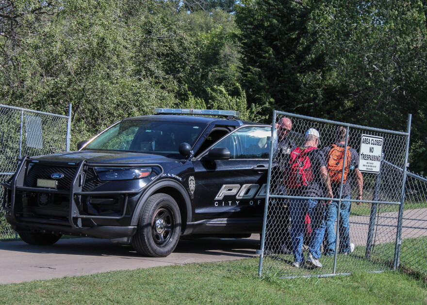 Members of HumanKind Ministries enter an encampment site on Monday at Chapin Park. Officers said only volunteers were allowed into the park to help move people out.