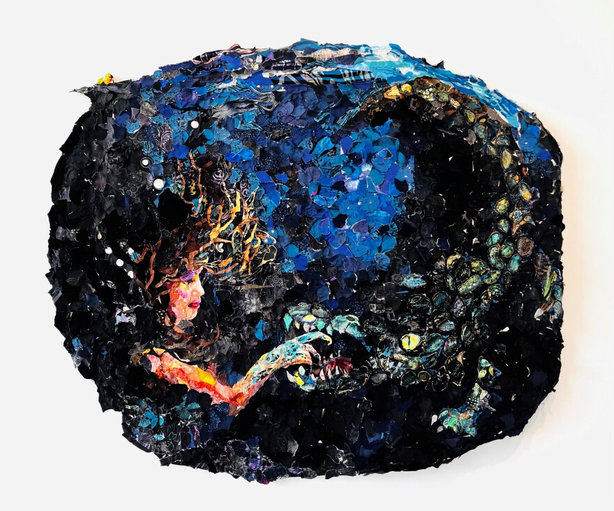 An quilt made from thousands of pieces of fabric depicts a young girl reaching into the mouth of a monster under the sea