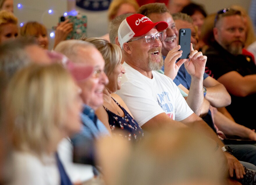 Mark Paneitz, of Wentzville, right in the red hat, reacts to comments from Sen. Ted Cruz (R-Texas) on Saturday during a campaign rally for Senate-hopeful Eric Schmitt at Piazza Messina in Cottleville.