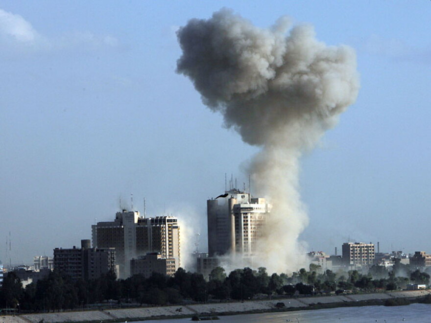 Smoke rises into the sky following one of three explosions Monday near Baghdad hotels.