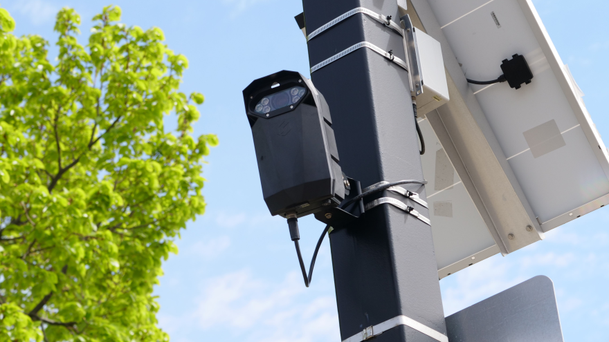 A solar-powered urban surveillance camera is mounted on a pole in this file photo.