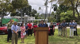 State Sen. Chris Lee, center, speaks at a news conference in Honolulu on Thursday, May 19, 2022.Lawmakers this year passed legislation creating a working group to develop ways to eliminate greenhouse gas emissions on transportation between the islands. (AP Photo/Audrey McAvoy)