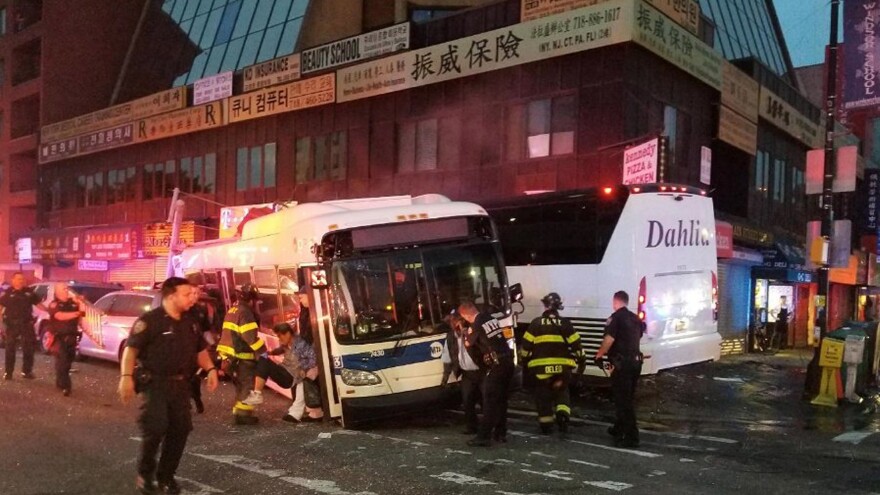 NYPD officers respond to a deadly crash involving two buses in the New York City borough of Queens on Monday.