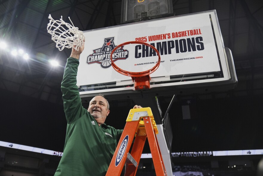 USF head coach Jose Fernandez celebrates after cutting down the net following his team's win against Rice in American Conference tournament title game in Fort Worth, Texas, on Wednesday, March 12, 2025.  He's reportedly returning to the metroplex as head coach of the Dallas Wings. 