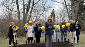 A woman stands in front of Stoneleigh Residence employees before they break ground on the new expansion. 