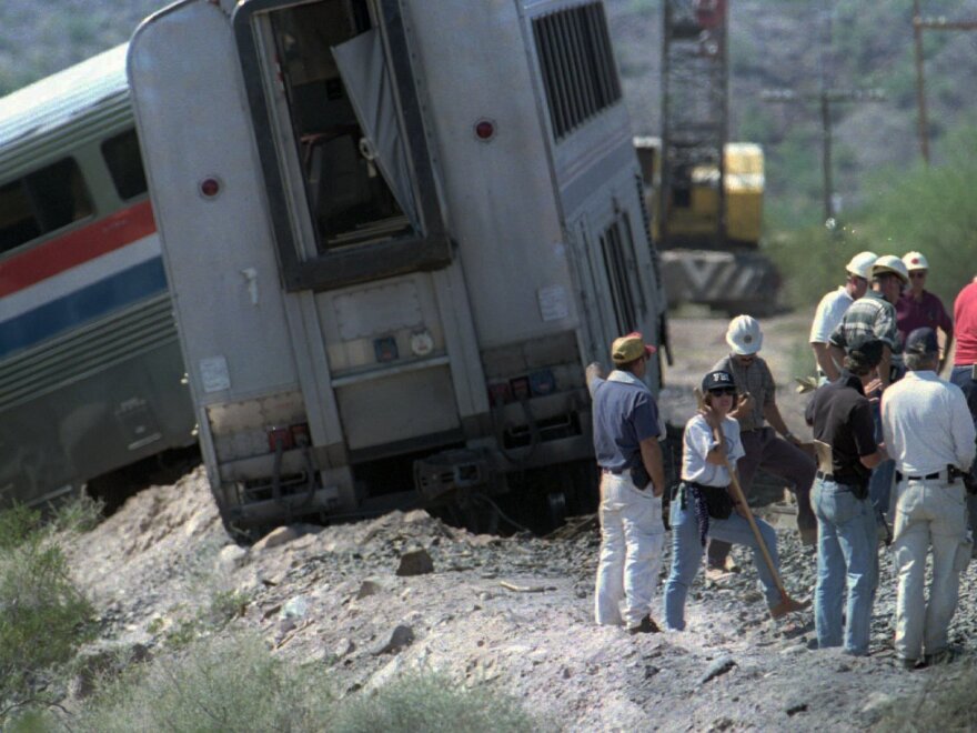 Federal investigators continue to search for clues beside the track on Oct. 11, 1995.