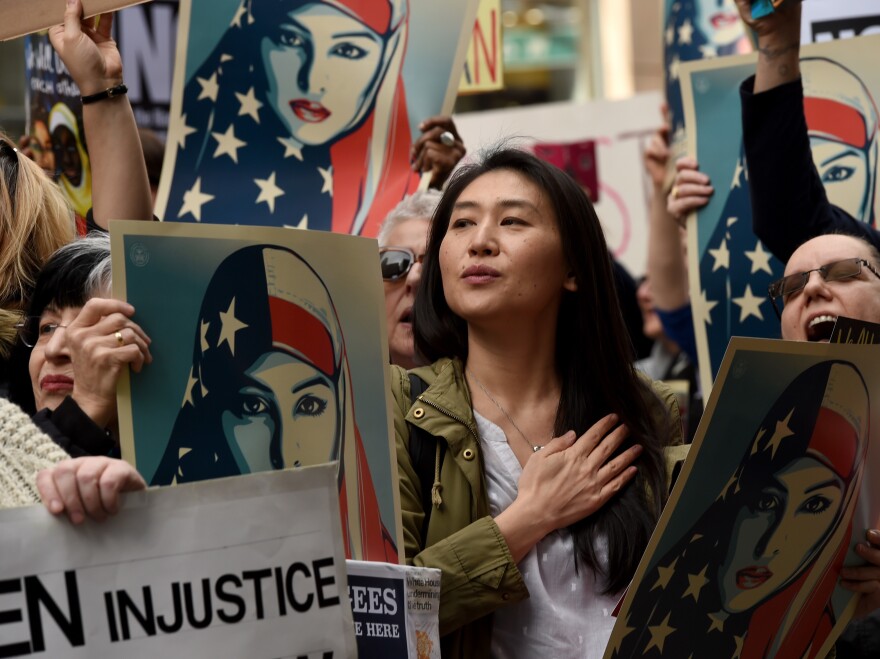 Protesters march in New York's Times Square on February 19, 2017, in solidarity with American Muslims and against the travel ban ordered by President Donald Trump.