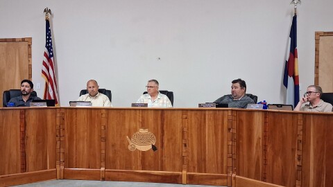 Members of the Mancos Board of Trustees sit behind the dais during a public meeting at Mancos Town Hall.
