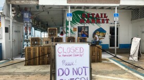 Employees of Key Fisheries, a Marathon, Fla. fish market that was damaged by Hurricane Irma, clean up debris. Their business is closed to the public due to all the damage done by the storm.