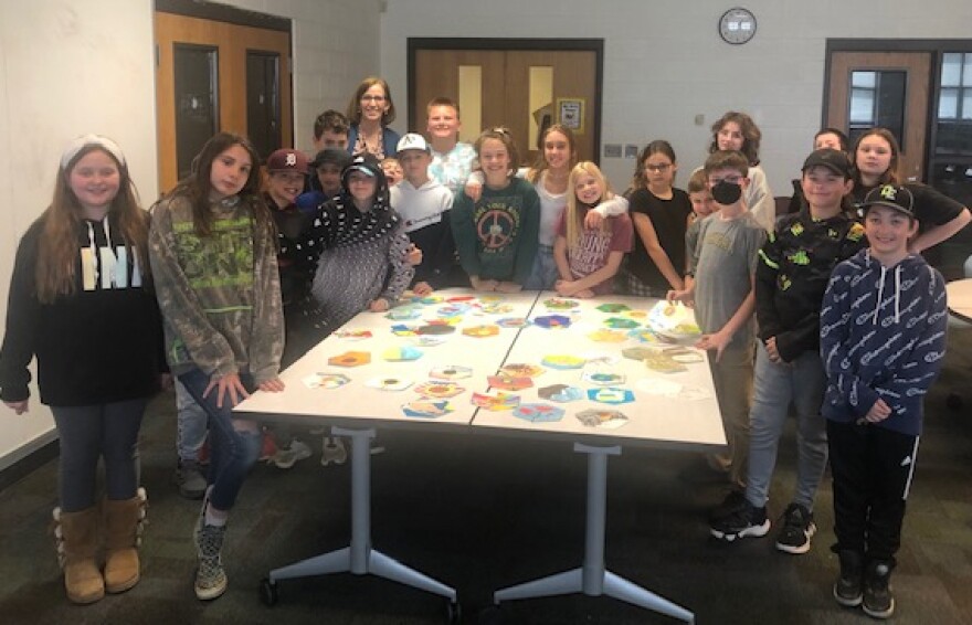 Jane Montero (back) with her students and their designs.