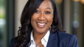 Headshot of woman in blue blazer and white shirt