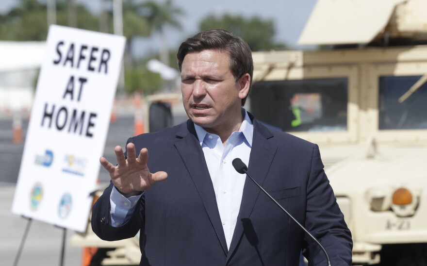 Florida Gov. Ron DeSantis speaks during a news conference at a drive-through coronavirus testing site in front of Hard Rock Stadium, Monday, March 30, 2020, in Miami Gardens, Fla. Gov. Ron DeSantis doesn't want the people on the Holland America's Zandaam where four people died and others are sick to be treated in Florida, saying the state doesn't have the capacity to treat outsiders as the coronavirus outbreak spreads.