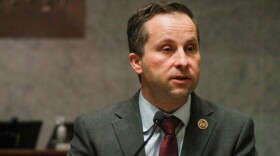 Sen. Spencer Deery is wearing a dark grey suit and speaking at the statehouse