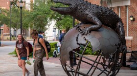Students walk by On Top Of The World, a statue outside of the University of Florida’s Warrington College of Business Administration’s&nbsp;undergraduate building in Gainesville. (Ethan Goddard/ Fresh Take Florida)