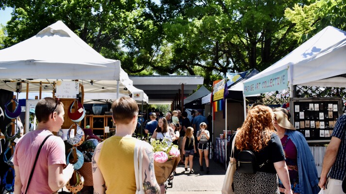 People wander through Eugene Saturday Market.