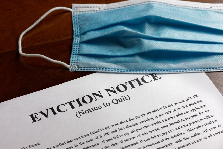 Surgical mask on top of an eviction notice.