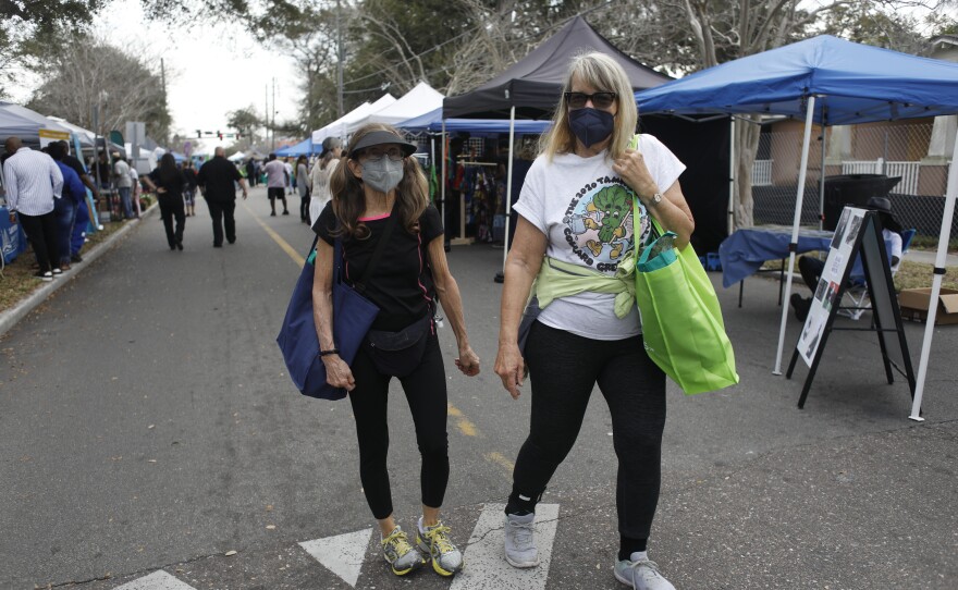 Festivals attendees are seen visiting vendors during the 2022 Publix Tampa Bay Collard Festival in St. Petersburg, Florida, on Saturday, February 19, 2022. Photo by Octavio Jones for WUSF