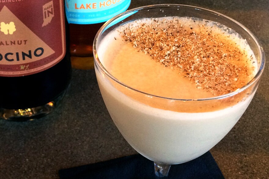 Place a piece of paper over half of the glass before dusting the surface with freshly ground nutmeg.