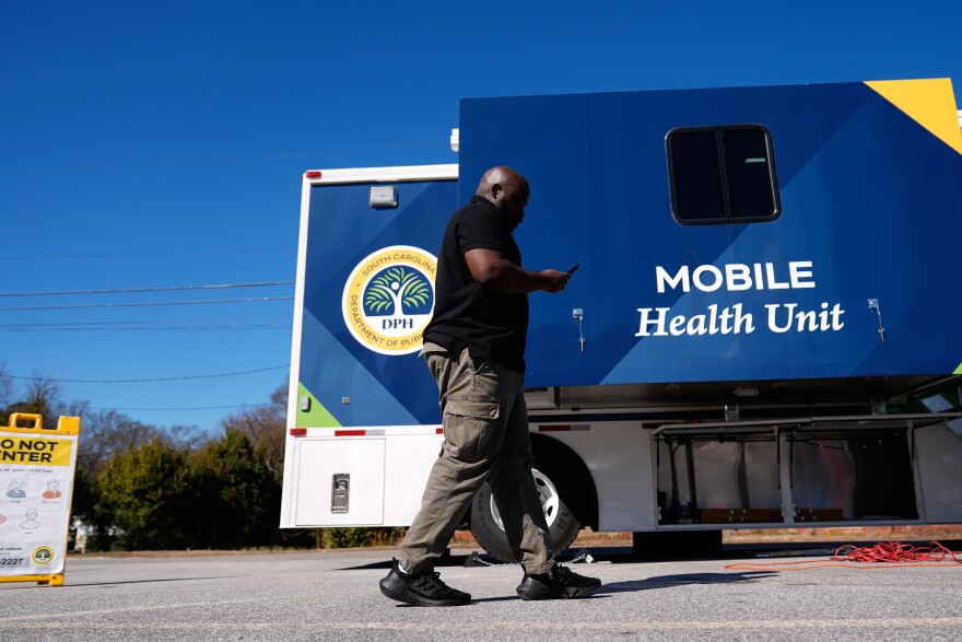 Jared Charles, a community engagement worker with the South Carolina Department of Public Health, walks outside of a mobile clinic in Inman, S.C, Friday, Feb. 13, 2026. (AP Photo/Erik Verduzco)