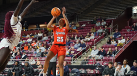 Alaina Rice (orange #25) takes a jump shot as a Boston College defender jumps towards her to contest the shot