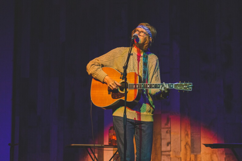 Brett Dennen performs on stage.