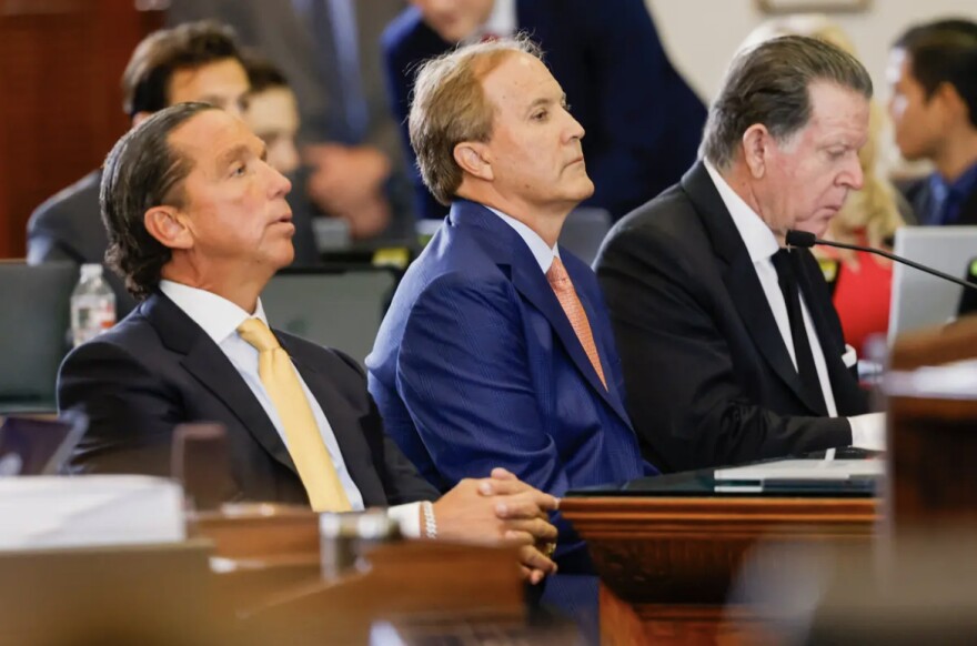 Attorney Tony Buzbee, suspended Attorney General Ken Paxton and attorney Dan Cogdell on the Senate floor on Tuesday. The attorneys are part of the team defending Paxton in his Senate impeachment trial.