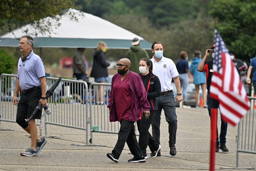 A steady stream of voters file into the Kentucky Exposition Center to cast their vote in the Kentucky primary in Louisville, Tuesday, June 23, 2020. 