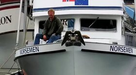 a man sits on a boat called Norseman