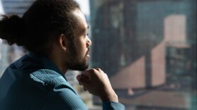 Close up of pensive African American man look in window distance thinking or pondering of future career opportunities. Thoughtful ethnic male make decision or plan. Business vision concept.