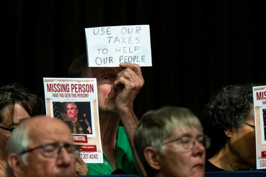 An audience member displays a sign directed toward Marion County Sheriff Kerry Forestal on Sept. 3, 2025, during the City-County Council’s Public Safety and Criminal Justice Committee meeting where his department presented its 2026 budget.