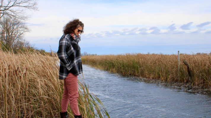 Brandy Toft, environmental director for the Leech Lake Division of Resource Management, looks down Oct. 20, 2025, at Pike Bay Channel, where the St. Regis Paper Co. Superfund Site’s water treatment plant pumps its effluent in Cass Lake.