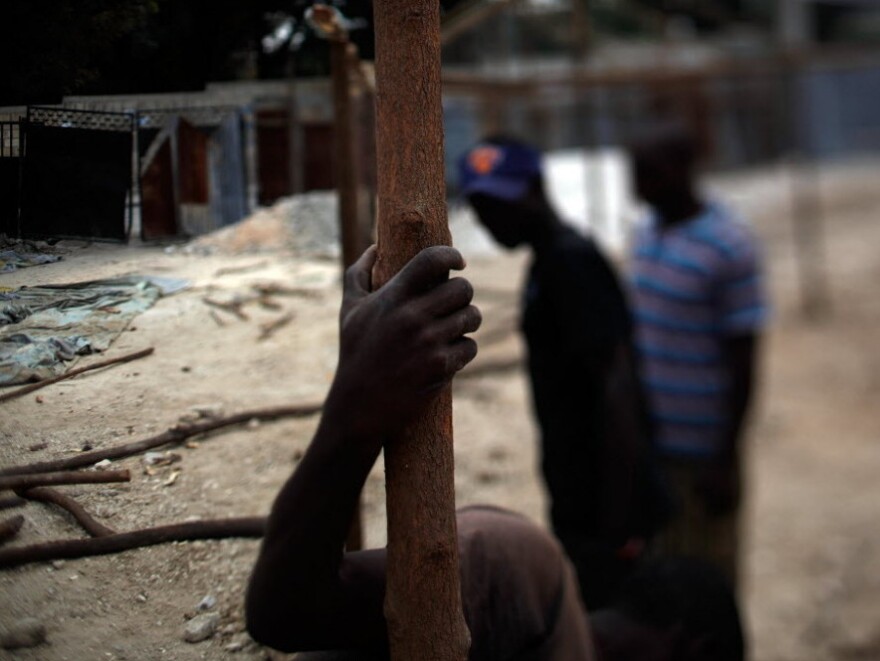 The crew uses rough-hewn sticks to build the classrooms.