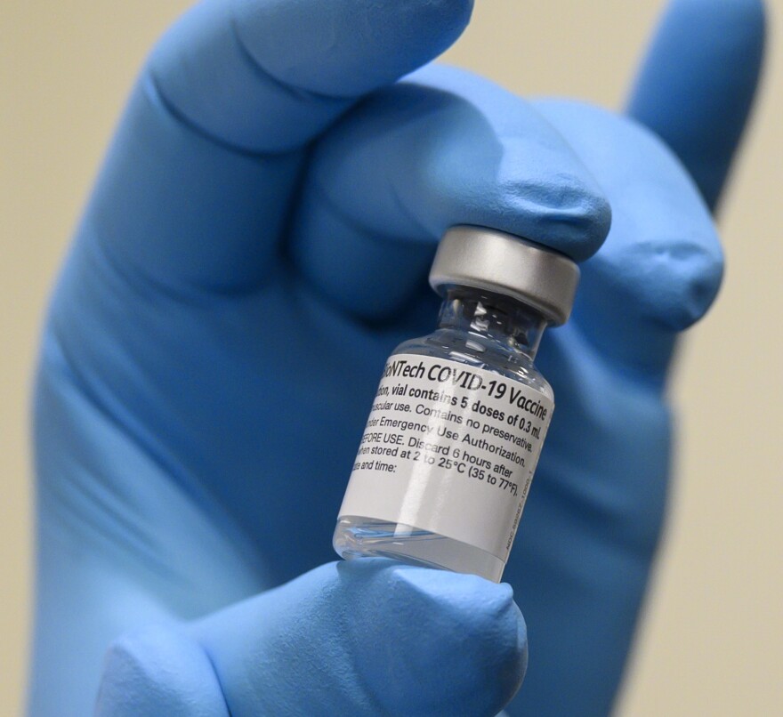 Army Spc. Angel Laureano holds a vial of the COVID-19 vaccine, Walter Reed National Military Medical Center, Bethesda, Md., Dec. 14, 2020. (DoD photo by Lisa Ferdinando)